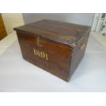 A stained pine deed-box with twin-carry-handles and painted date '1891', 23 ins wide (59 cms)
