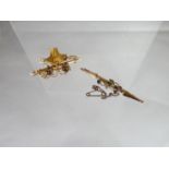A 9ct antique floral design bar brooch together with a yellow metal basket brooch, unmarked