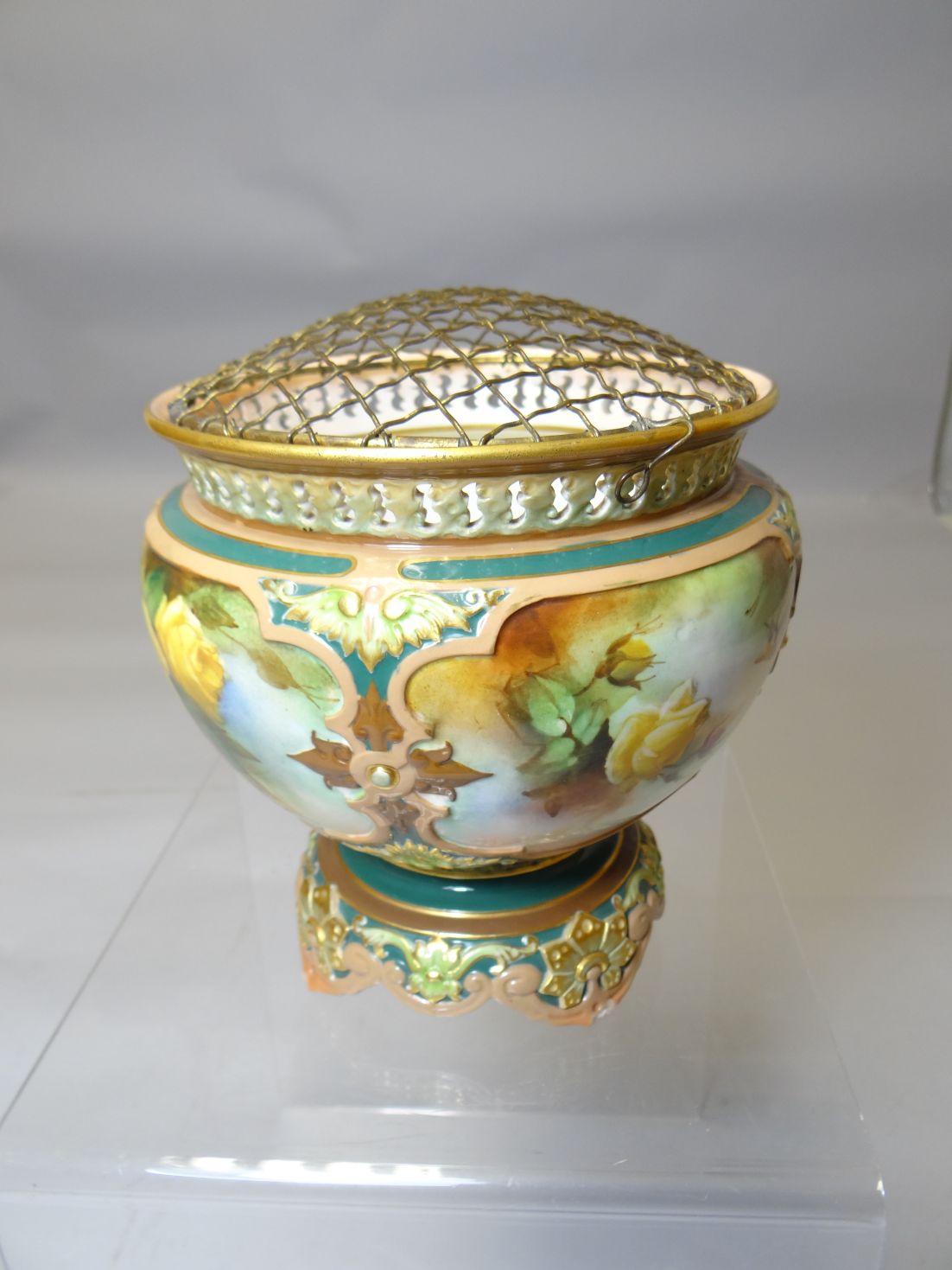 A Royal Worcester porcelain footed rose bowl decorated with four panels of roses surrounded by