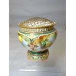 A Royal Worcester porcelain footed rose bowl decorated with four panels of roses surrounded by