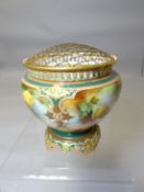 A Royal Worcester porcelain footed rose bowl decorated with four panels of roses surrounded by