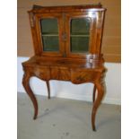 A fine quality nineteenth century cross-banded walnut and ormolu galleried cabinet-on-stand with two
