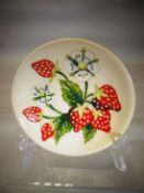 A Moorcroft pottery 'Brittany Strawberries' pattern dish, 4.75 ins diameter (12 cms)