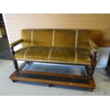 An Edwardian billiards room couch on raised foot-stand and mustard upholstery, 73 ins wide (186