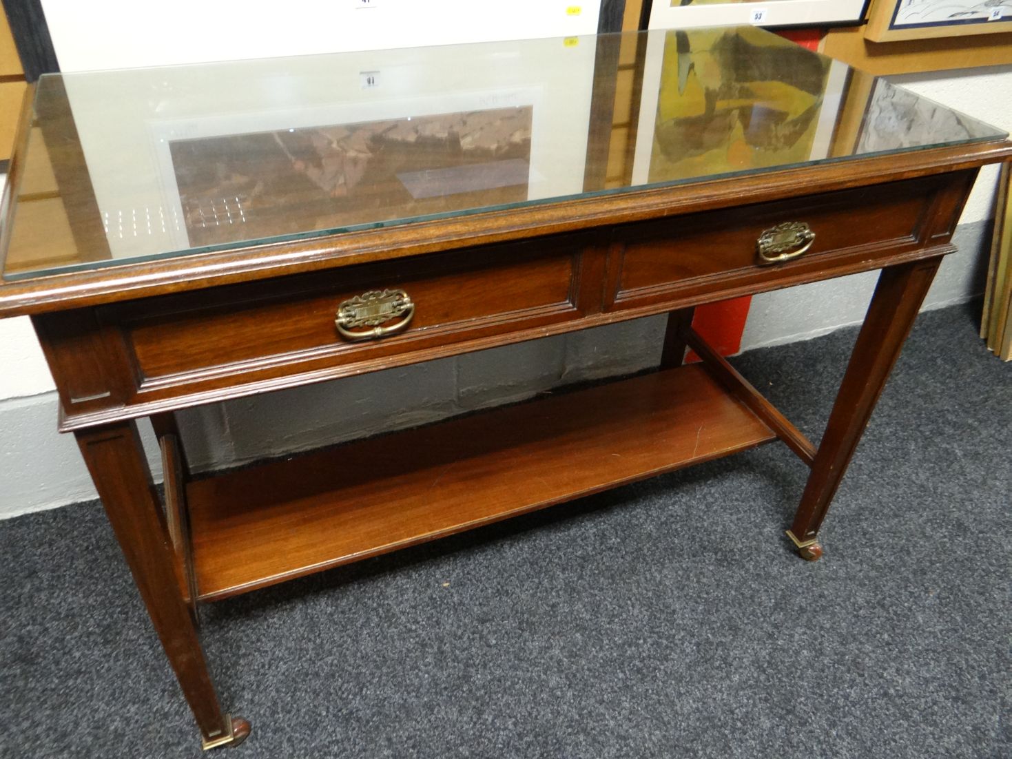 A mahogany two drawer side-table, 42 ins wide (107 cms)