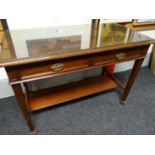 A mahogany two drawer side-table, 42 ins wide (107 cms)