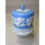 A Staffordshire blue and white jasperware stilton dish with stand base decorated with applied