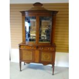 An Edwardian inlaid mahogany cabinet-sideboard, having a bow-front two-door glazed top with shaped