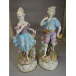 A pair of Capodimonte circular based peasant figures in pastel glazes, 29 ins high (74 cms)