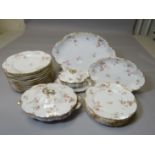 A Limoges floral decorated and gilt porcelain dinner service comprising a large platter, smaller