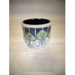 A Moorcroft pottery planter 'Peacock Parade', 3.5 ins high (9 cms)