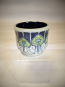 A Moorcroft pottery planter 'Peacock Parade', 3.5 ins high (9 cms)