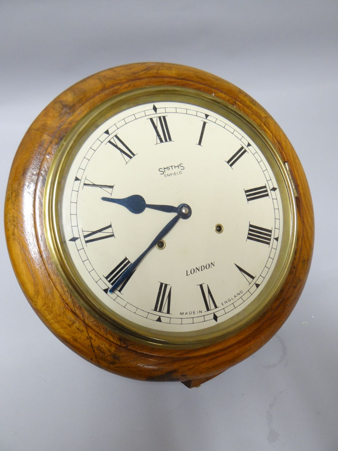 A Smiths of Enfield circular dial classroom wall-clock having Roman Numerals to the white enamel