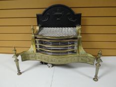 A good brass and iron serpentine fire basket with pierce work frieze and urn finials, 30 ins wide (