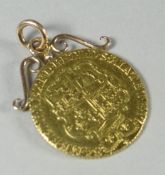 A George III gold Spade Guinea attached to a scrolling mount