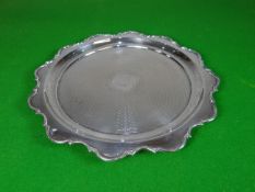 A circular silver tray with machine decoration to the interior, central circular uninscribed
