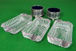 A trio of silver mounted cut-glass ashtrays; together with two circular footed silver mustard