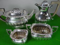 A four-piece silver teaset of fluted oval form and with gadrooned borders, the tea and coffee pots