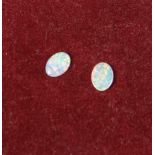 A pair of loose small opals