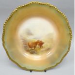 A Royal Worcester blush ivory cabinet plate of fluted-circular form and with moulded gilt rim, the