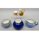 A Locke & Co blue and white cream jug and sugar basin with all-round raised geometric decoration,