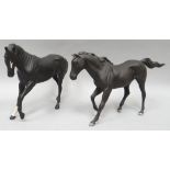 Two Royal Doulton standing sculptures of playful black horses in matt finish