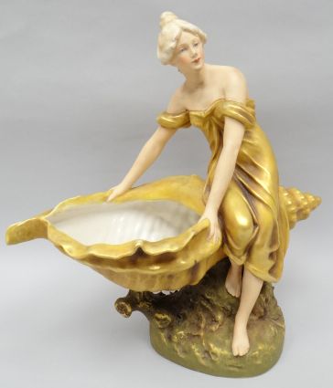A Royal Dux table-centre piece in the Art Nouveau style and in the form of a gilt robed lady