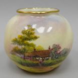 A Royal Worcester blush ivory small globular vase, painted with a thatched cottage and English
