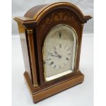 A Wurttemberg inlaid mahogany arched chiming mantel clock of architectural form with silvered dial