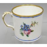 A small Sevres porcelain floral painted and gilded white ground mug