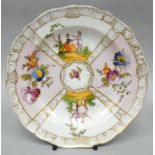 A Meissen pictorial panelled plate of four scenes and with gilt bordering, 7.5 ins diam (19 cms)