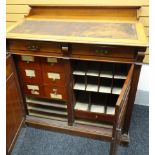 A large turn-of-the-century mahogany clerking-desk having a sloped front above two top drawers on