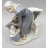 A Royal Copehagen porcelain model of a scarf wearing girl feeding a grey and white calf, on a