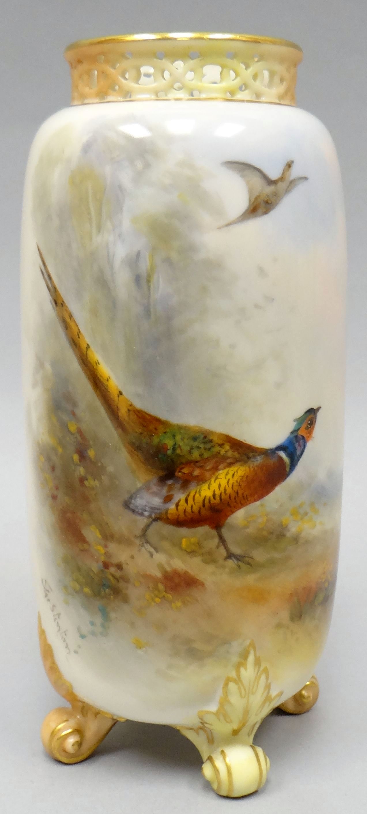 A Royal Worcester four-footed cylindrical vase with pierce-work neck, painted with pheasants in a