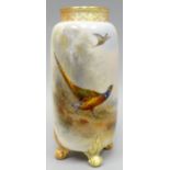 A Royal Worcester four-footed cylindrical vase with pierce-work neck, painted with pheasants in a