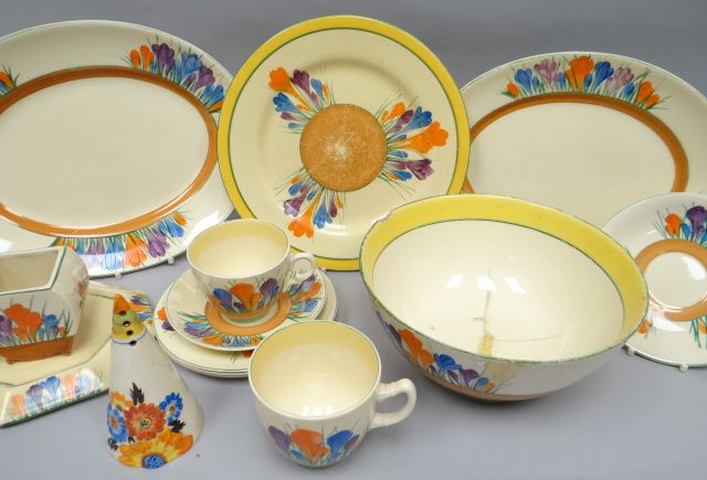 A parcel of Clarice Cliff 'Crocus' pattern tableware including teapot stand, two cups and saucers,