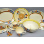 A parcel of Clarice Cliff 'Crocus' pattern tableware including teapot stand, two cups and saucers,