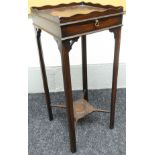 A late nineteenth century delicate mahogany kettle-table with shaped gallery top and candle slide