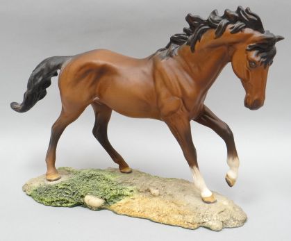 A Royal Doulton sculpture of a chestnut horse 'The Winner' in matt finish on a naturalistic base
