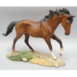 A Royal Doulton sculpture of a chestnut horse 'The Winner' in matt finish on a naturalistic base