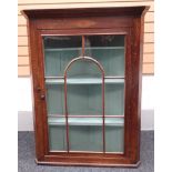 A good nineteenth century Welsh oak hanging-corner cabinet having a single glazed door separated