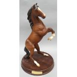 A Royal Doulton sculpture of a rearing horse 'Spirit of the Wild' in matt finish on a circular