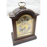 An Edwardian mahogany encased chiming bracket clock with arched silvered dial, maker's mark for