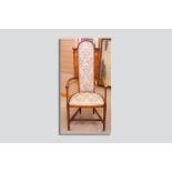 An Art Nouveau mahogany and inlaid highbacked armchair with later upholstered seat and back, the