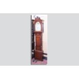 A 19th Century oak and mahogany longcase clock with arched twin swan pediment hood, single arched