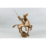 A mid 20th Century stylized bronze figure of an Indian Brave on horseback standing upon a rocky