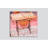 A 19th Century walnut games table and workbox, the burr walnut veneered top inlaid with a