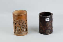 Two Chinese bamboo brush pots, one carved with a scene depicting men amongst trees, the other