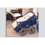 A 1930s Tan/Sad model 560 vintage twin axle canvas hooded baby's pram in good condition,