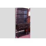 A dark oak Jacobean style dresser, shaped pierced frieze over a panel backed and shaped fronted